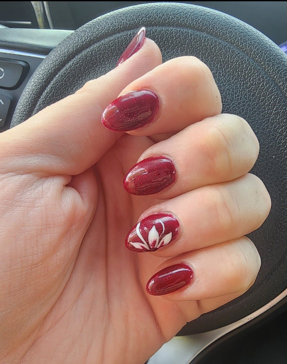 Uñas rojo burdeos con flor pintada a mano
